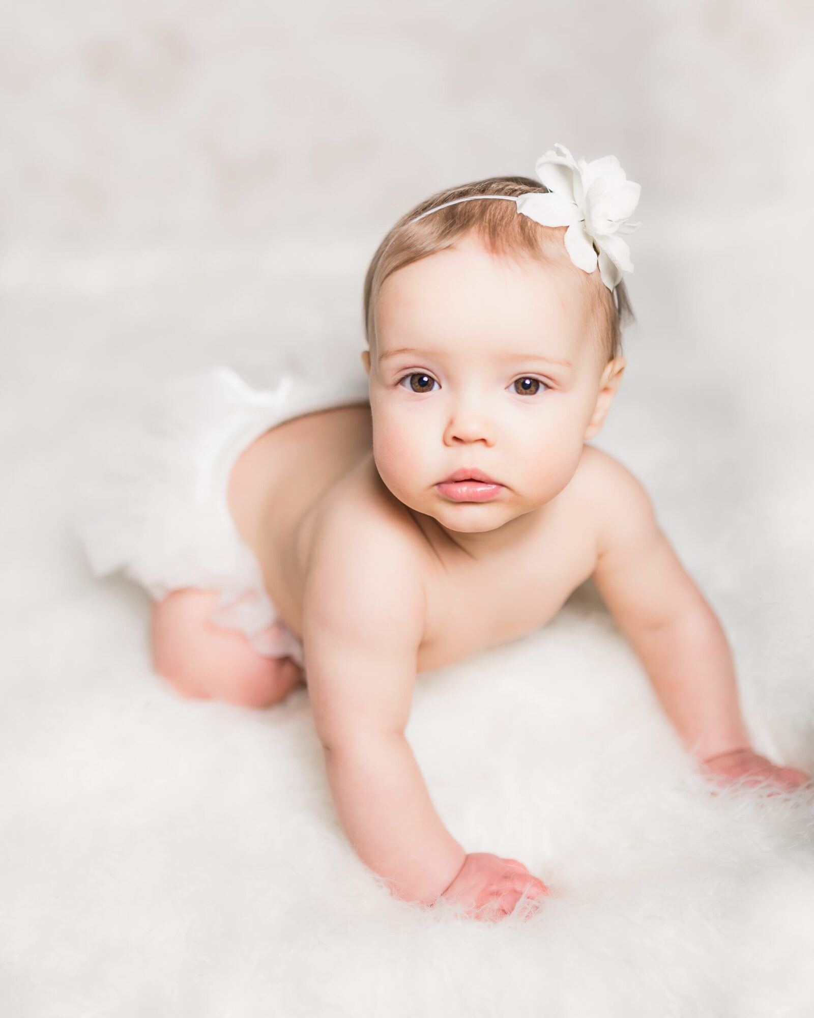 baby girl in tutu on white fur